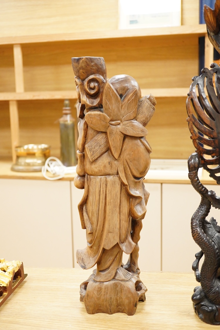 A large Indonesian hardwood Garuda group and a Chinese hardwood figure of a Luohan, largest 61cm high